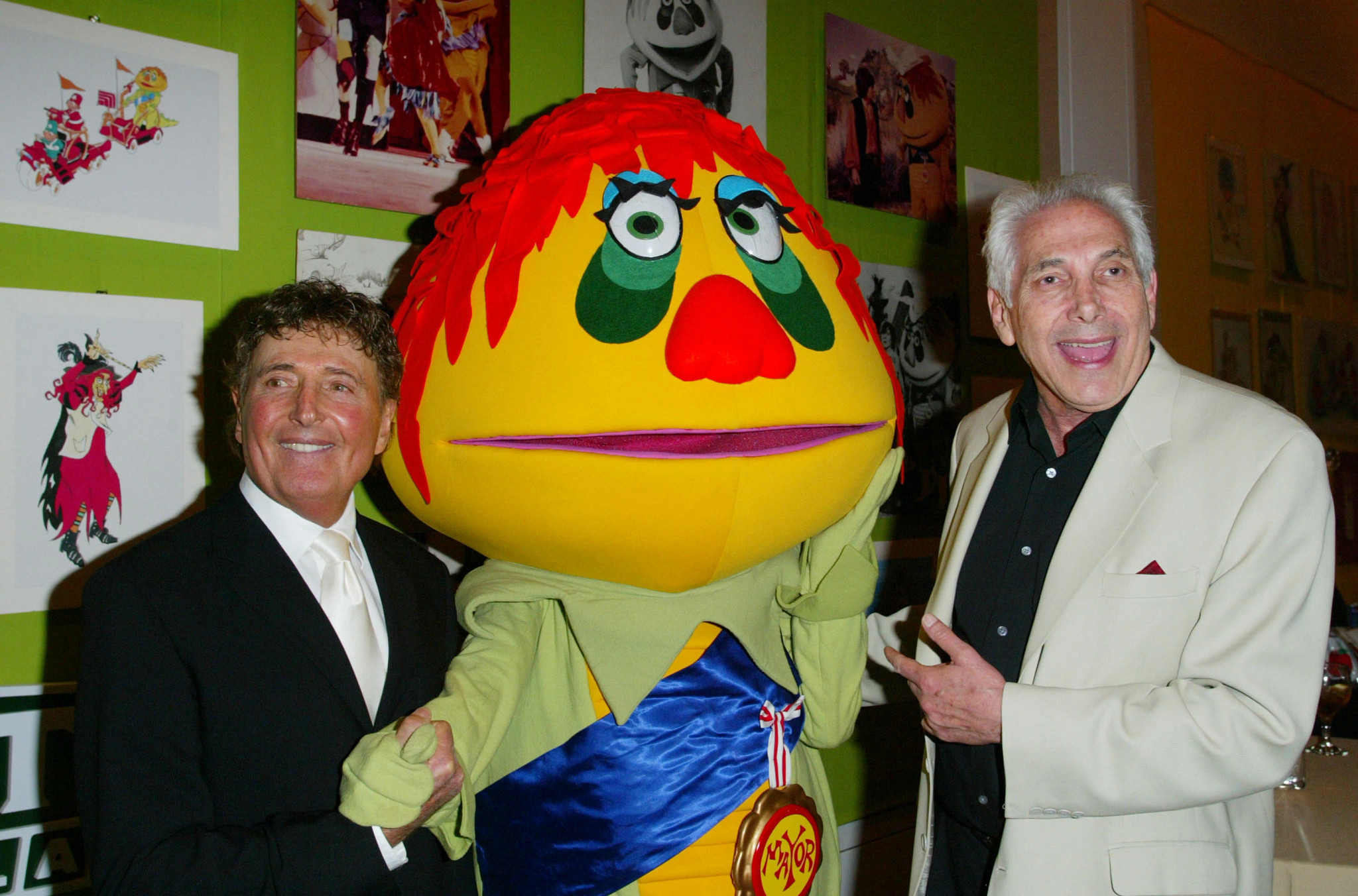 brothers sid and marty krofft stand with a puppet dressed as H.R. pufnstuf