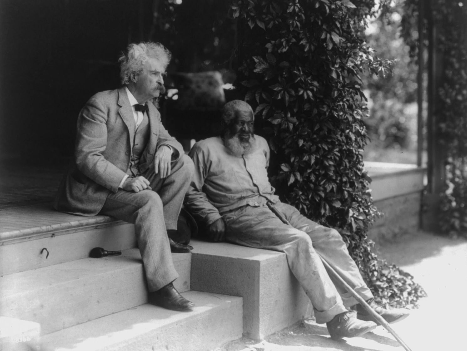 13 Fascinating Facts About Mark Twain Mark Twain and John T. Lewis seated together on stairs