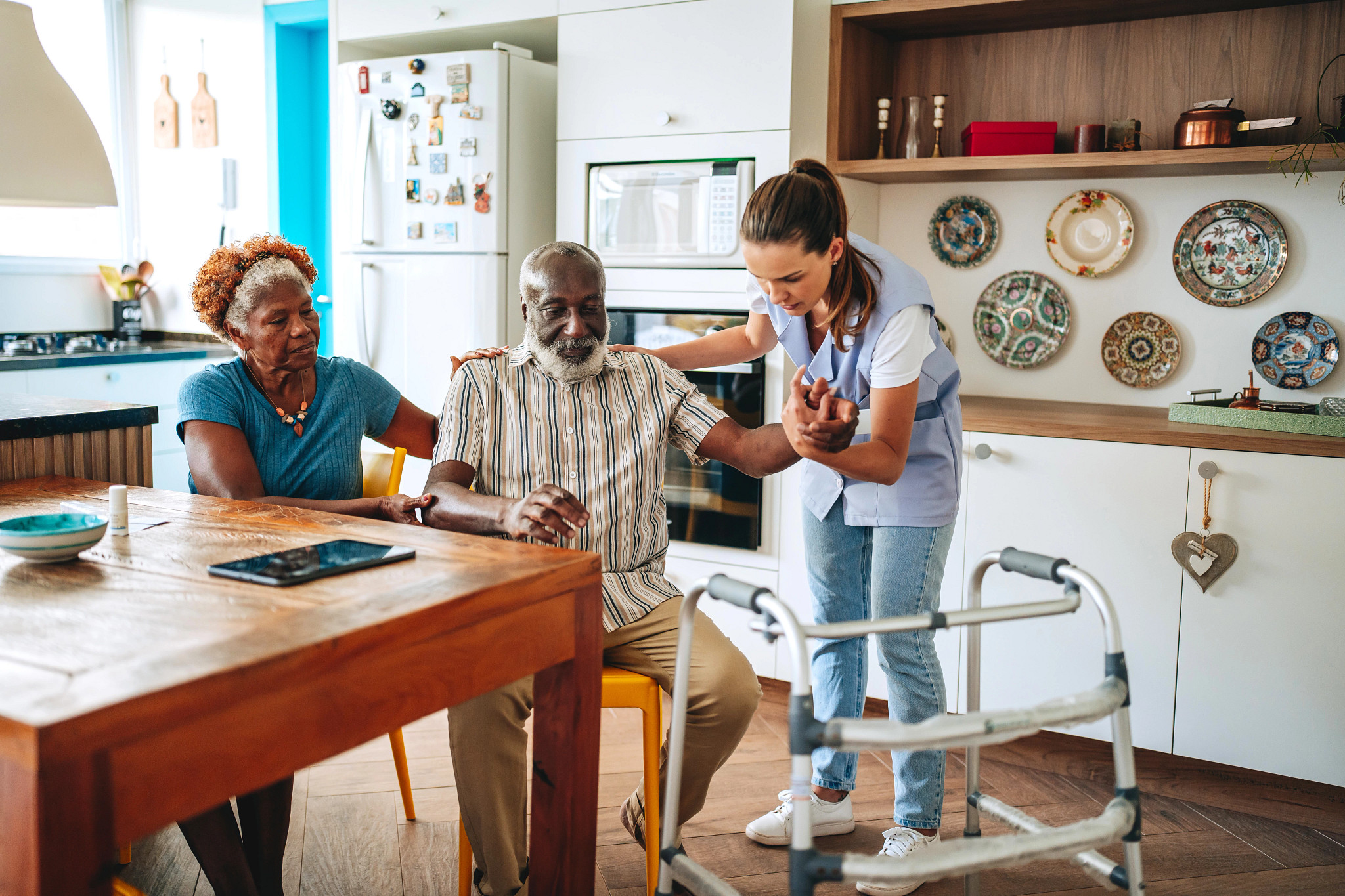 a caregiver helping a person use a walker