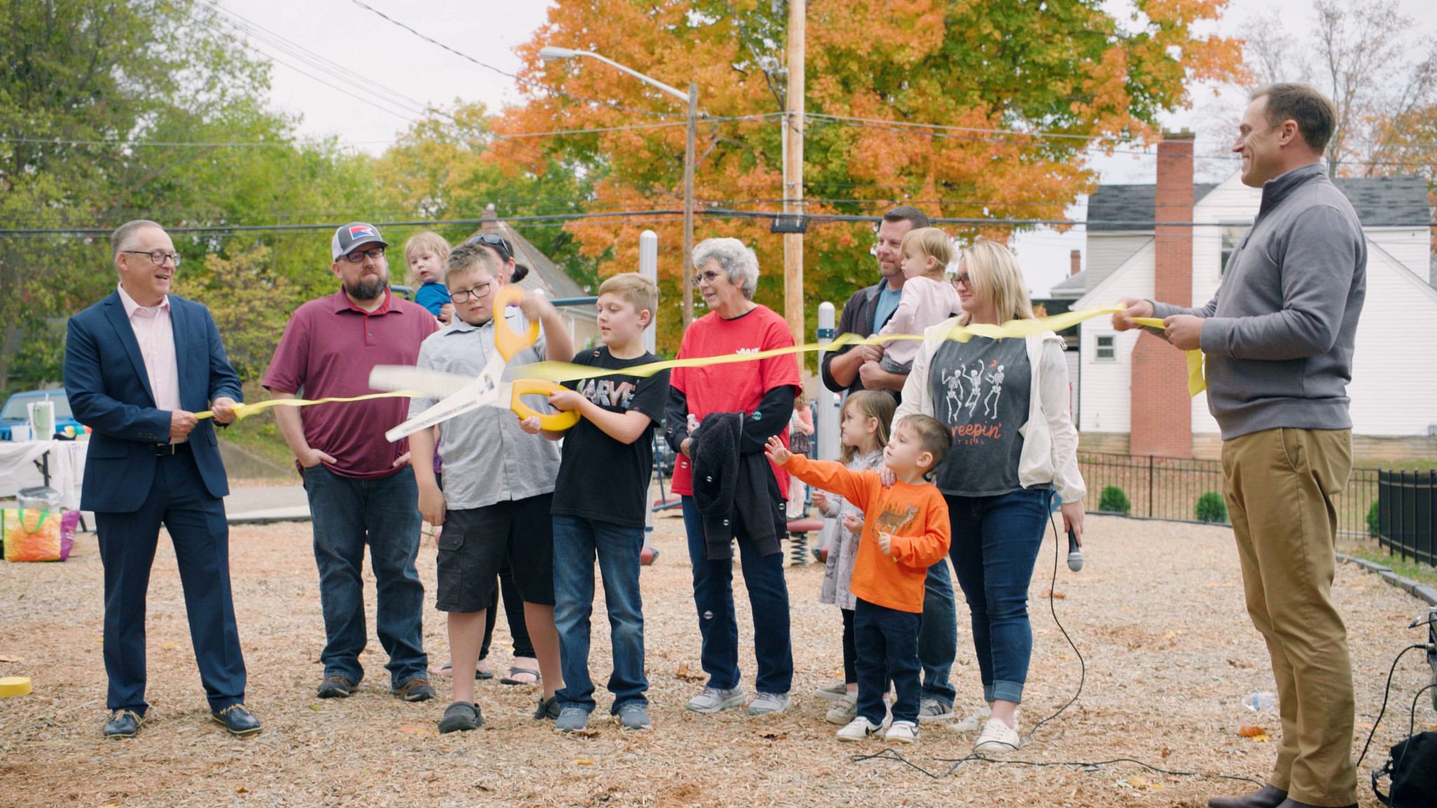 people cutting a ribbon
