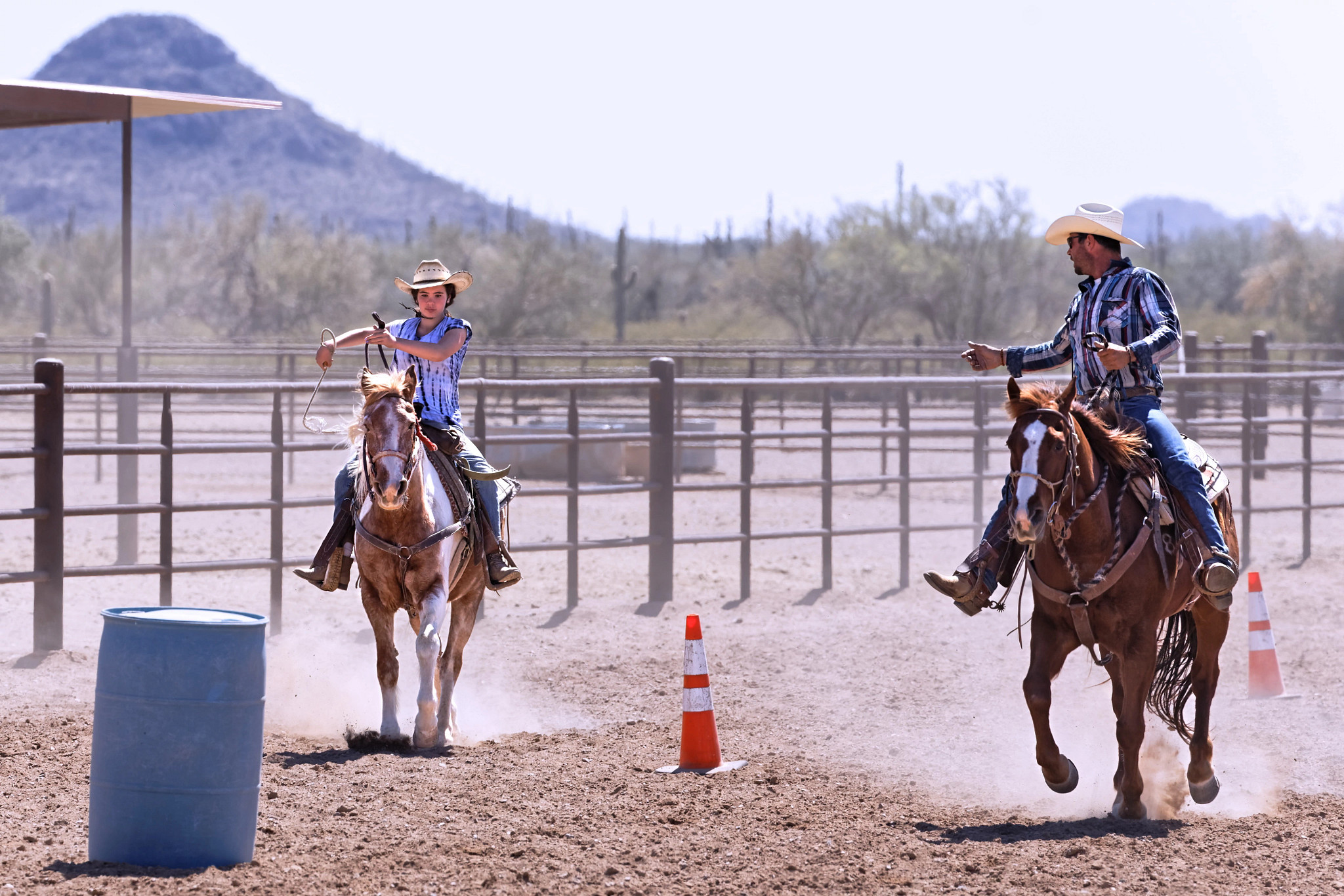 people riding horses at a ranch