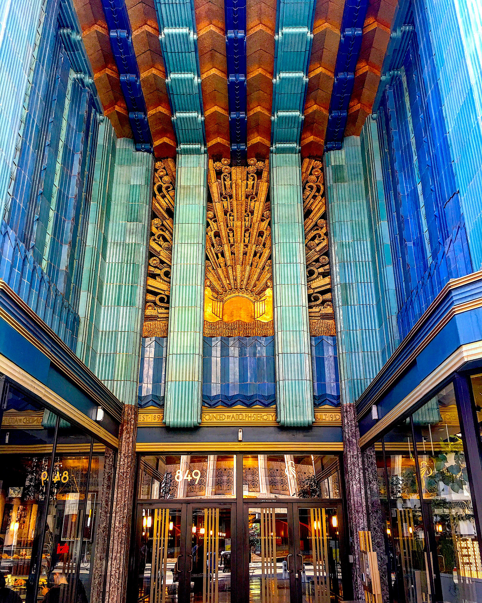 the entrance to a a colorful building with historic architecture