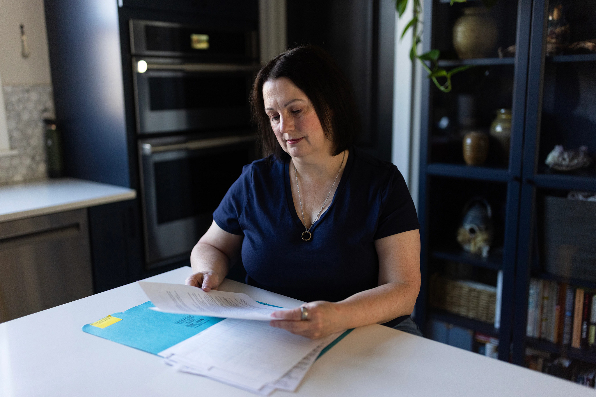 Joy Frank-Collins looking at papers in a folder