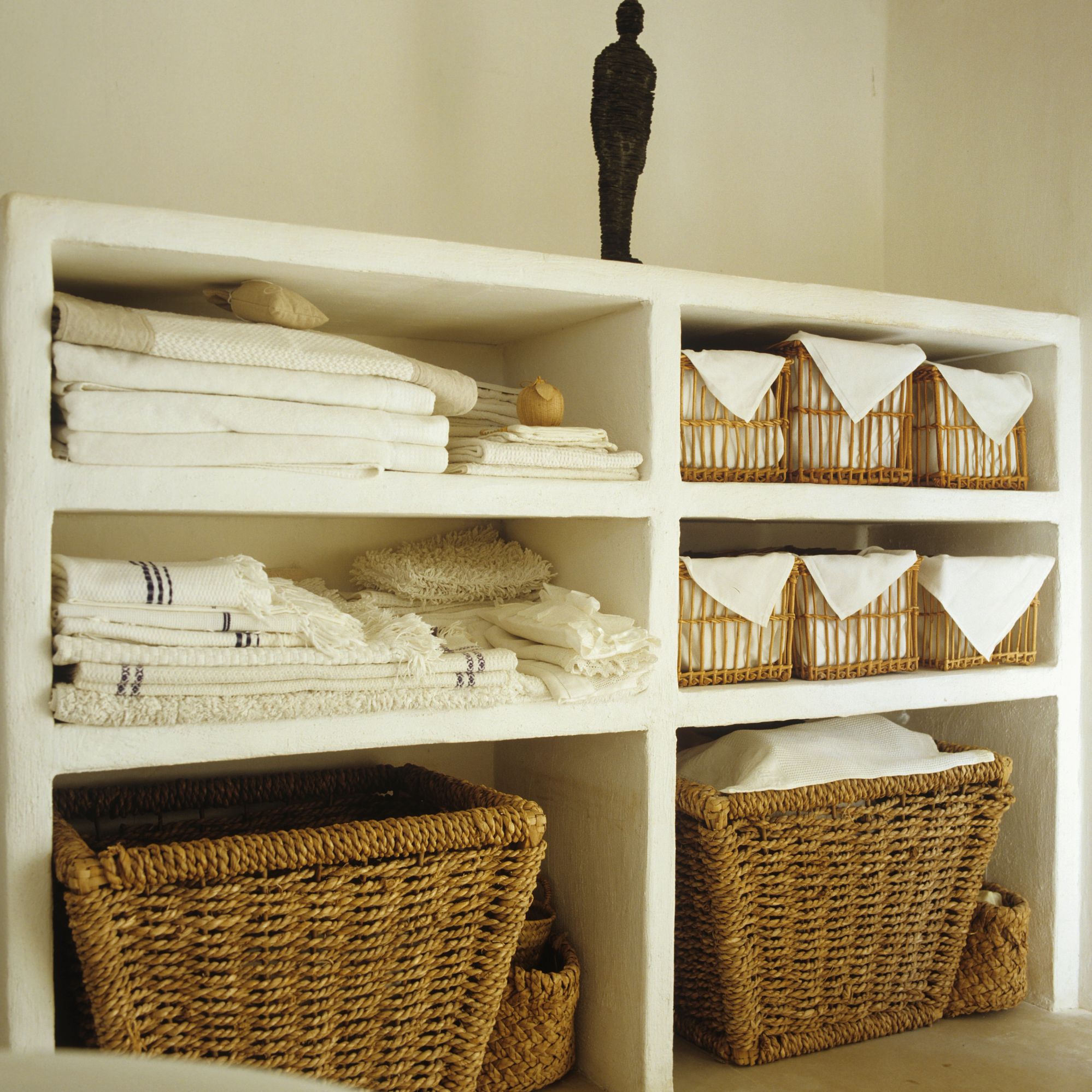 try wicker storage containers neatly folded linen in a bathroom closet