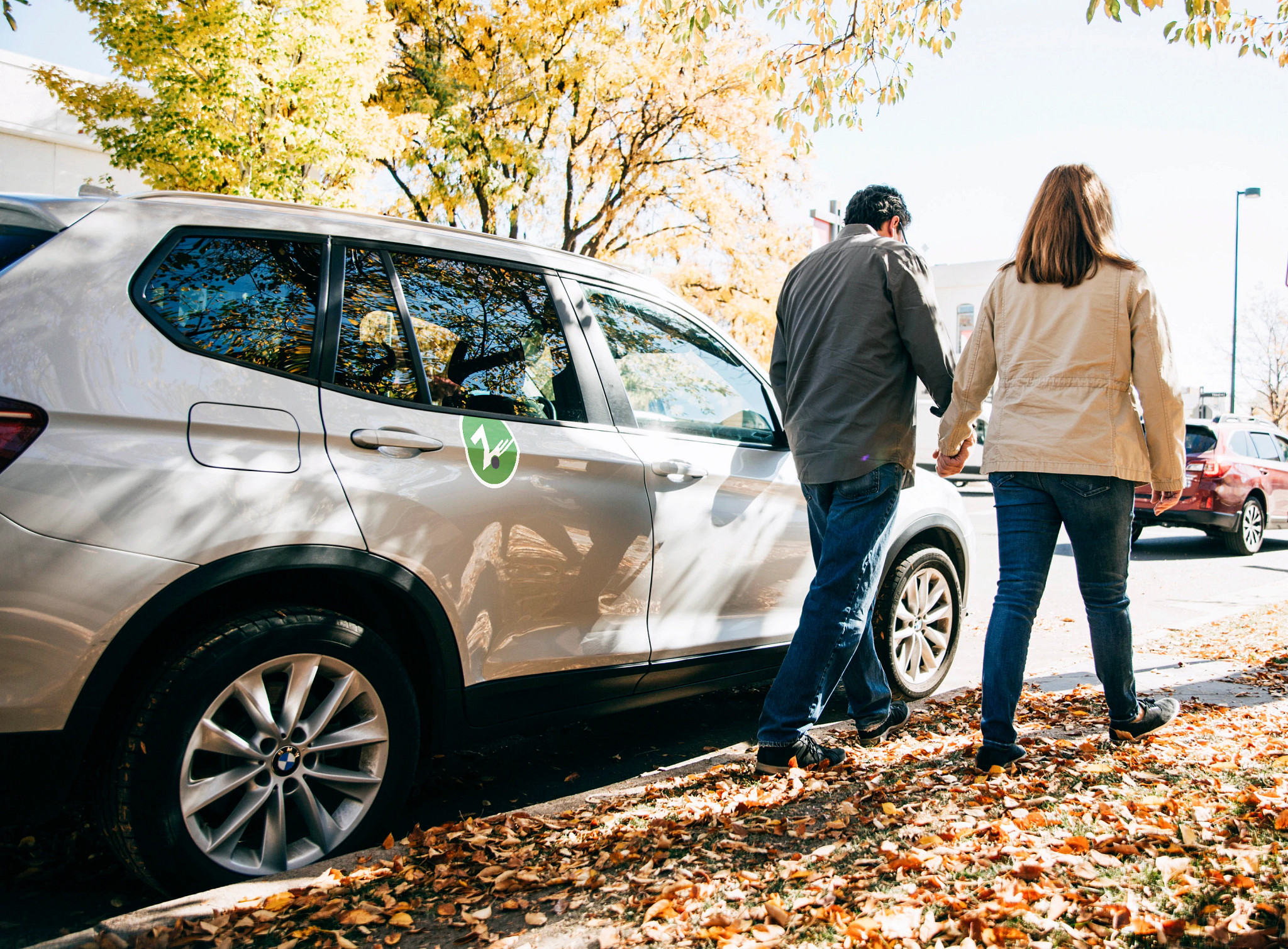 Couple walking by a car