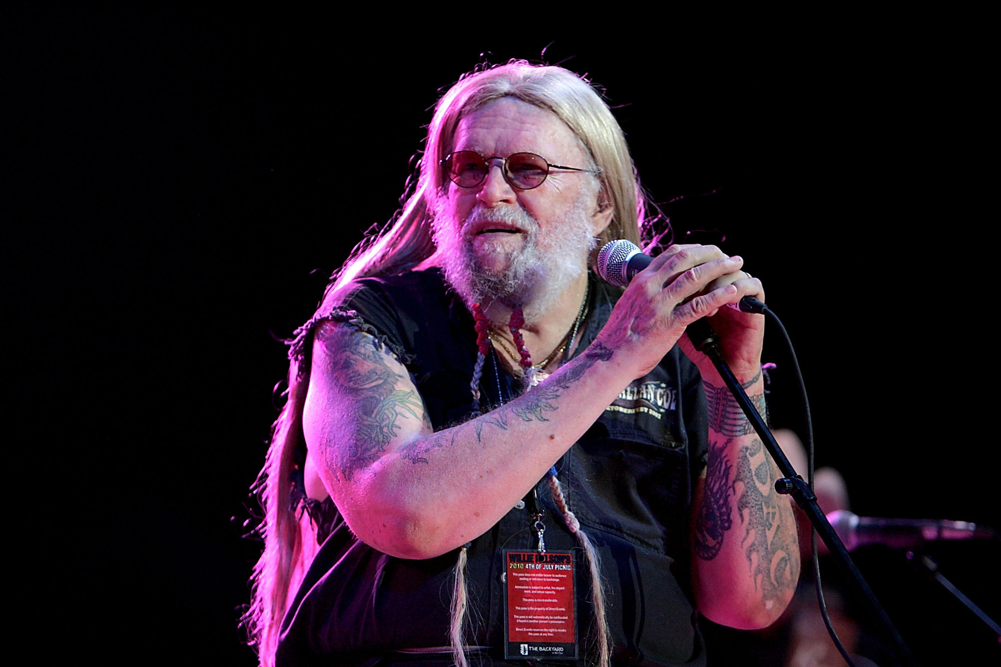 david allan coe performing on stage while holding a microphone