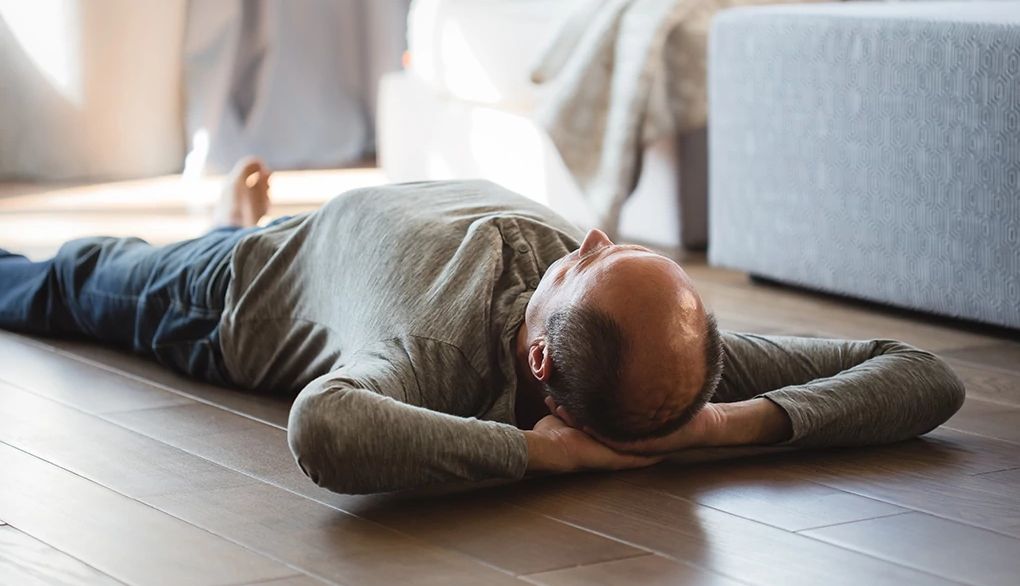 The body scan meditation may help your sleep A man lying on his back on the floor at home