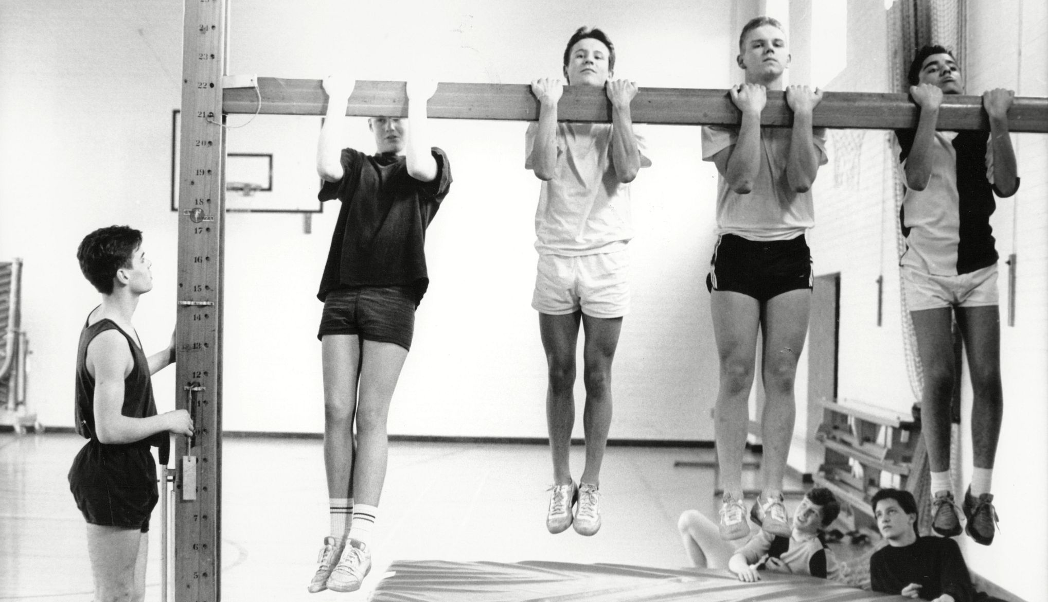 Presidential Fitness Test black and white image of people doing pull ups