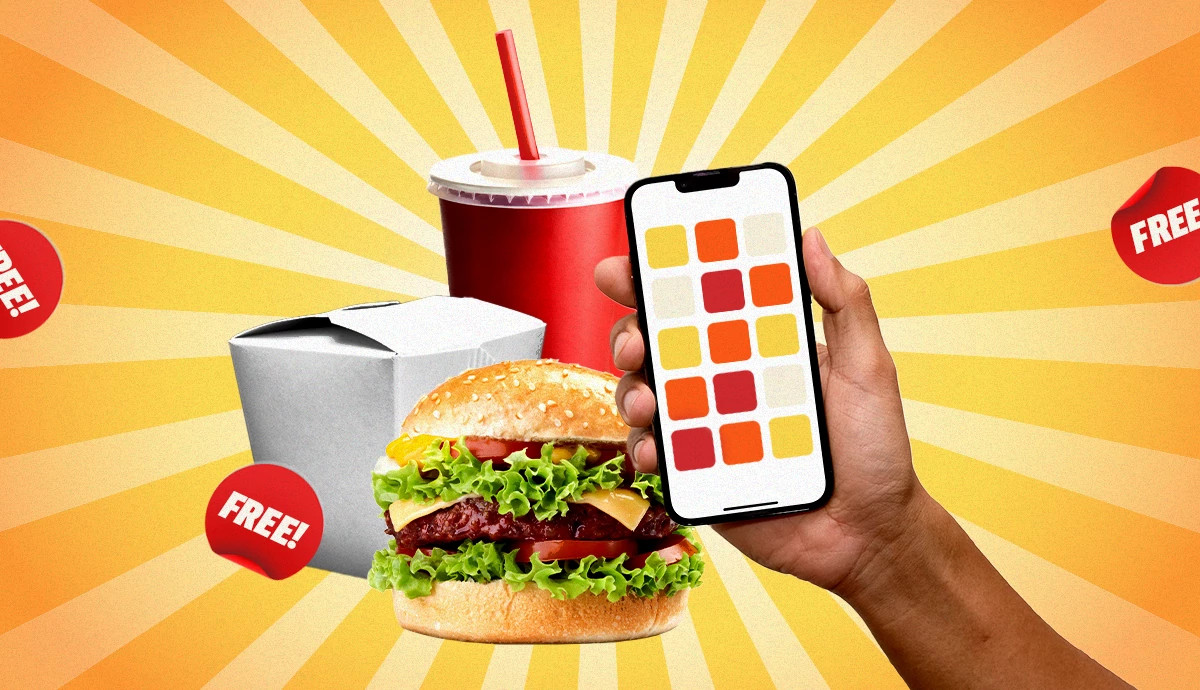 A hand holds a smartphone displaying app tiles, surrounded by free food.