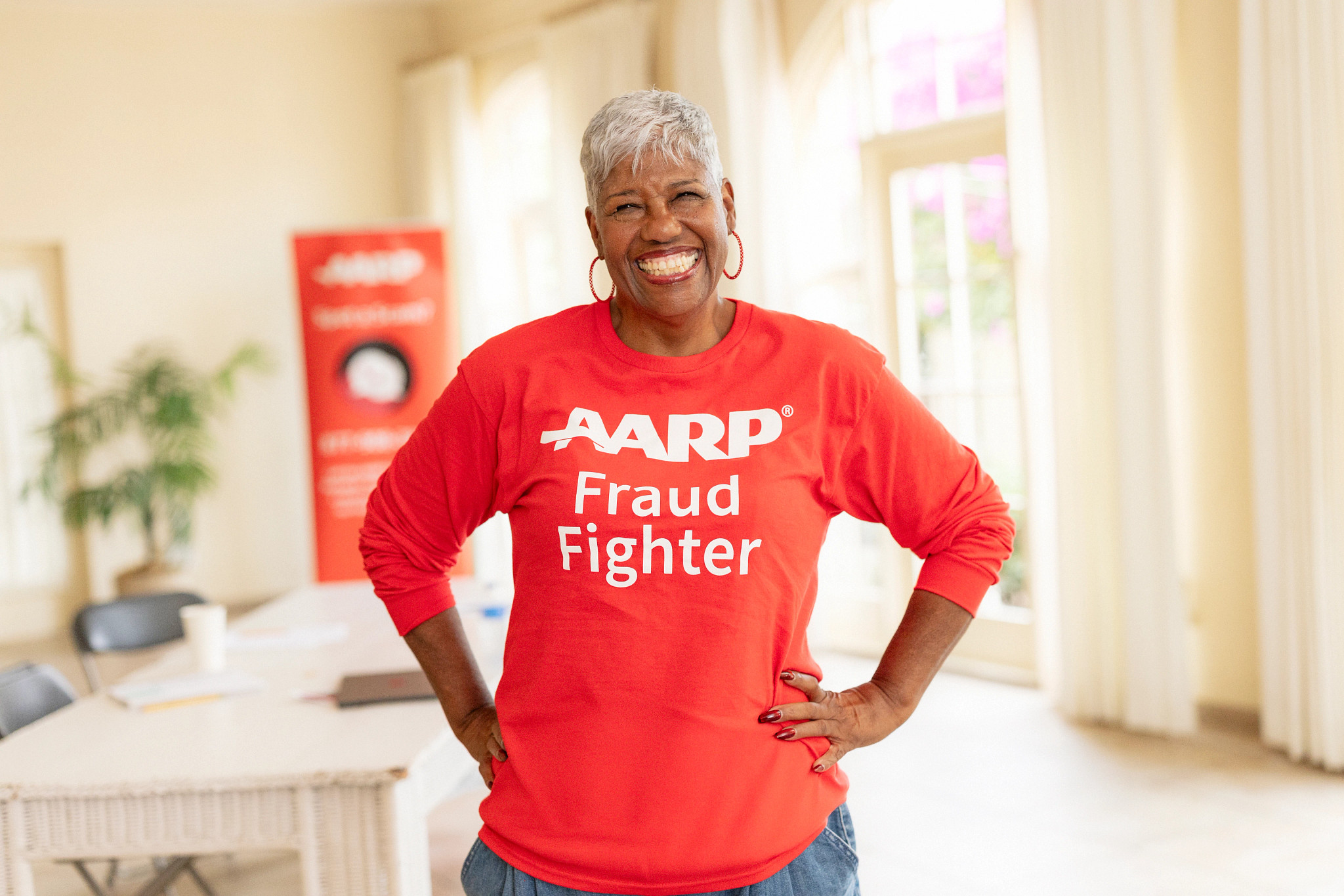 a woman wearing a shirt that saya a a r p fraud fighter