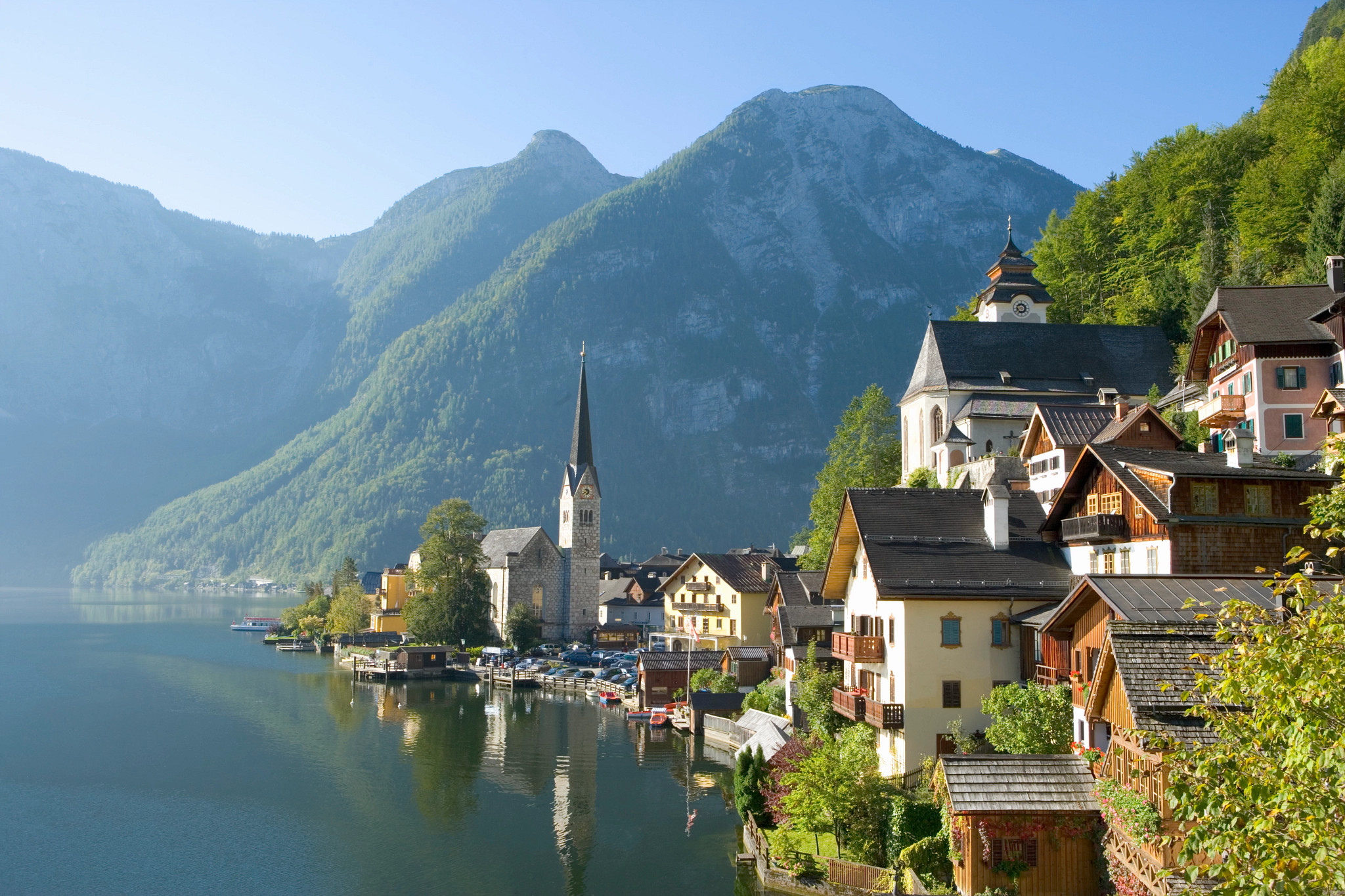 houses and a cathedral near the water in salzburg, austria
