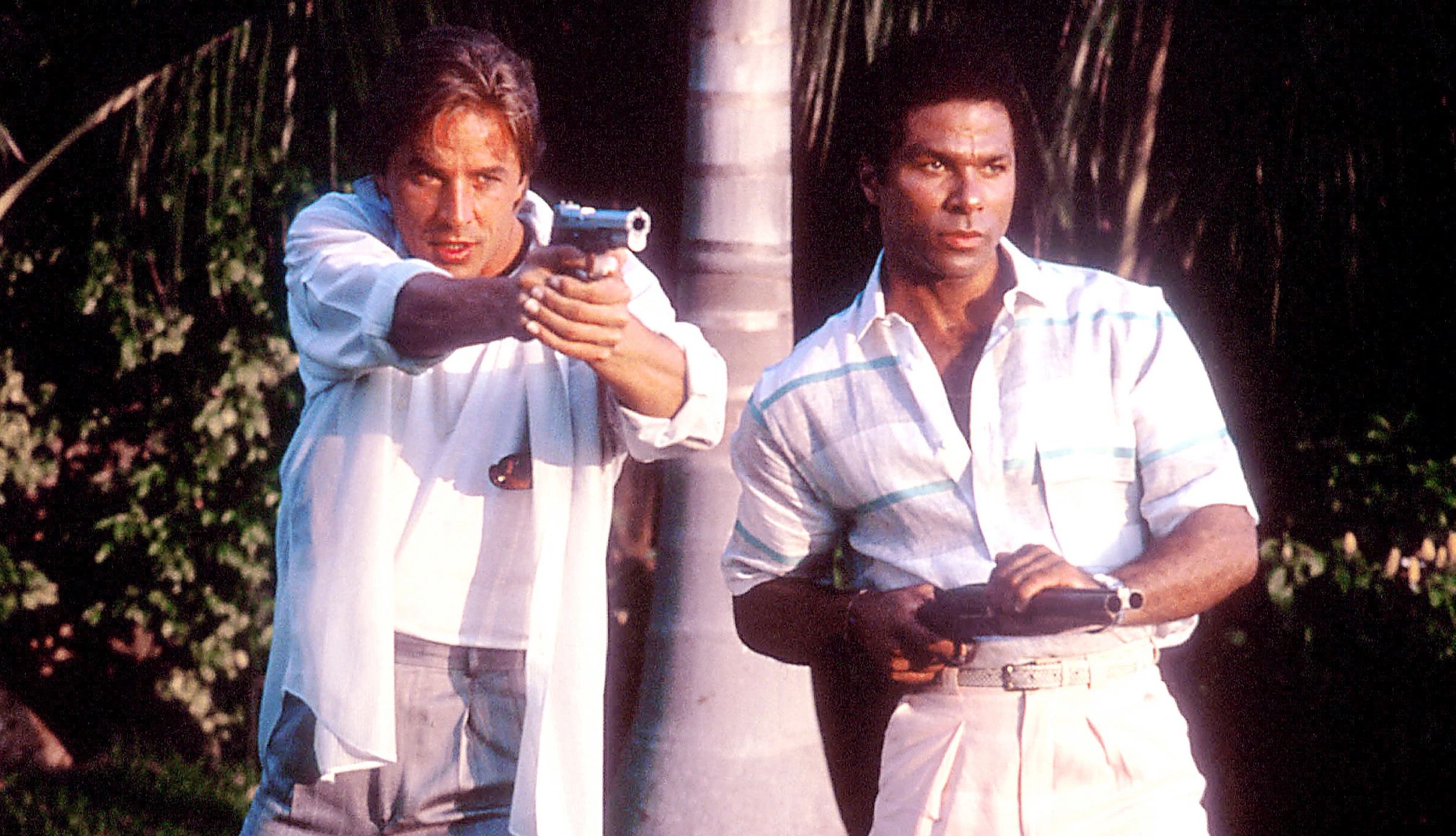 Don Johnson and Philip Michael Thomas in Miami Vice Don Johnson and Philip Michael Thomas both holding guns in a scene from the television series Miami Vice