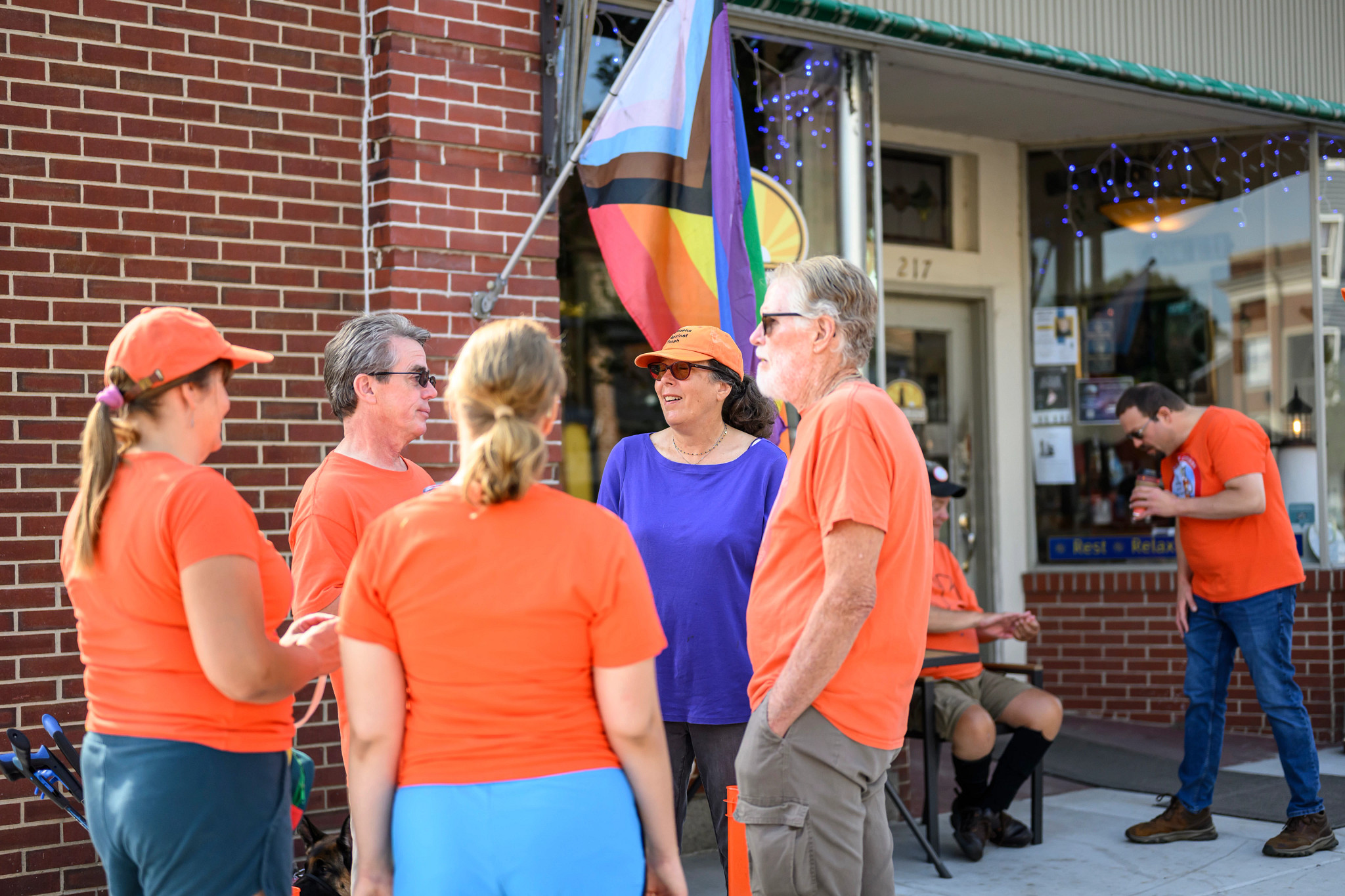 A photo shows Kim Clark chatting with fellow Citizens Against Trash outside Concord Point Coffee in Havre de Grace.