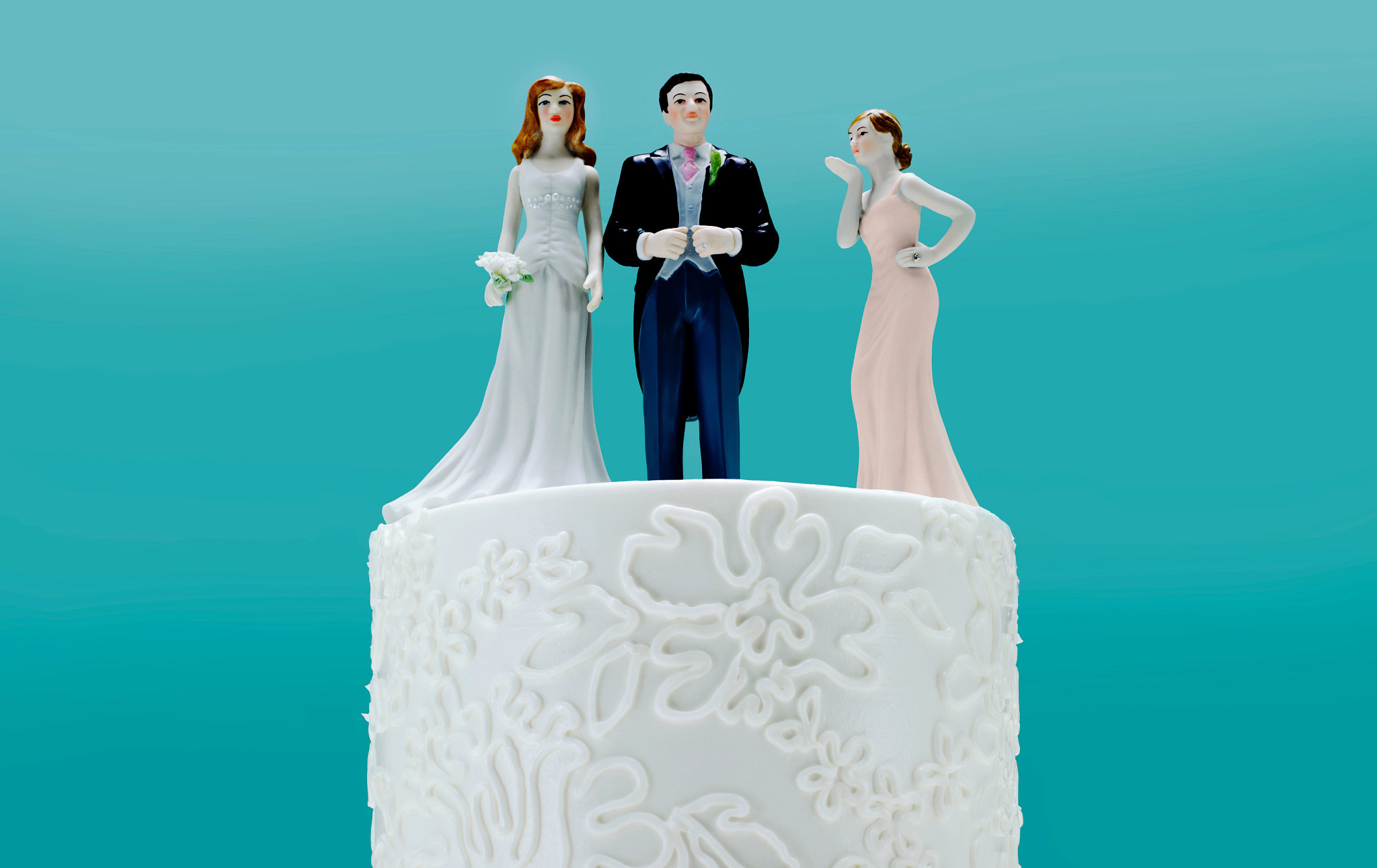 Wedding Cake with 3 toppers, a couple and a 2nd woman.