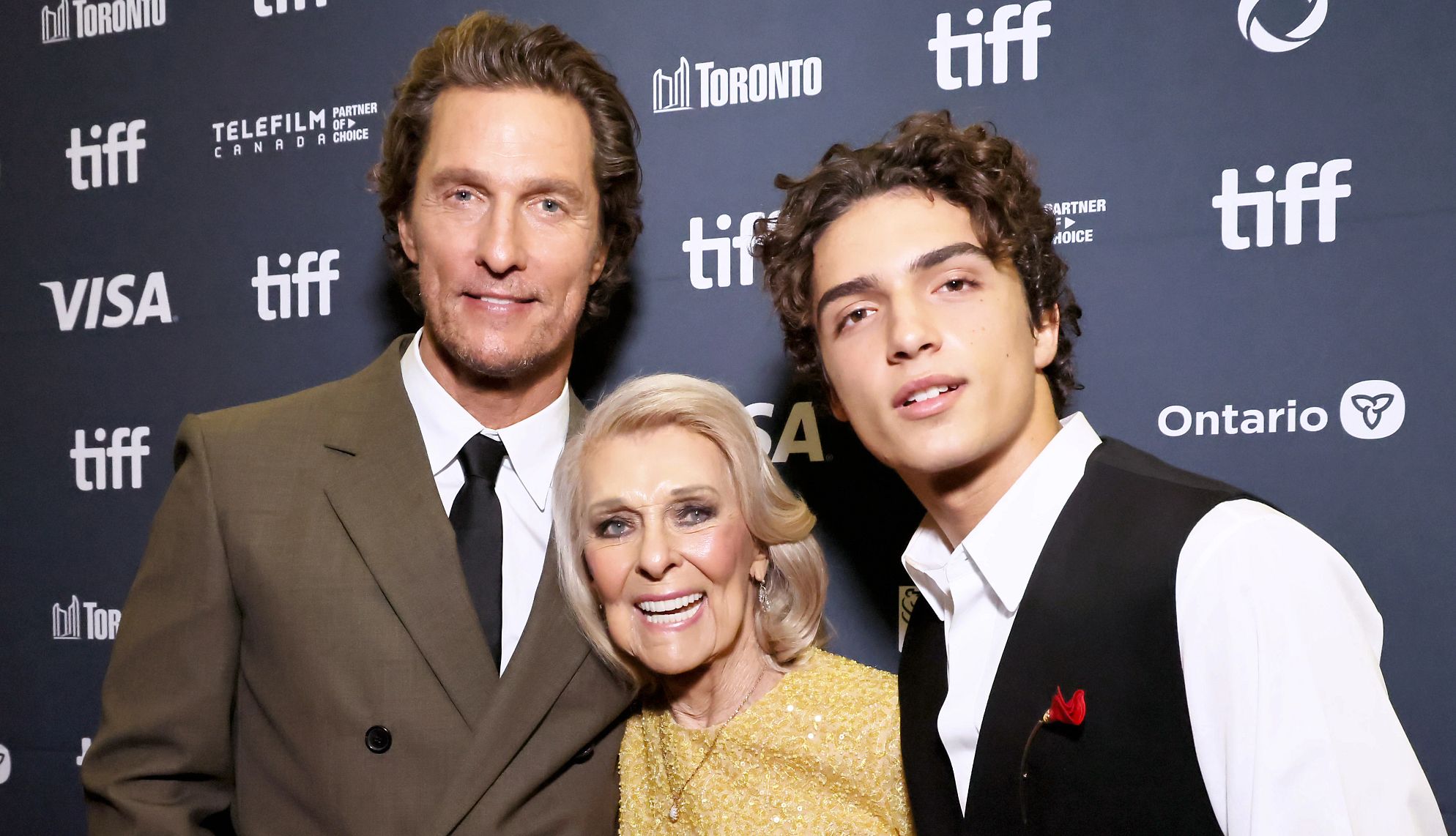 McConaughey’s New Movie is a Family Affair matthew mcconaughey smiling with his mother and son on the red carpet