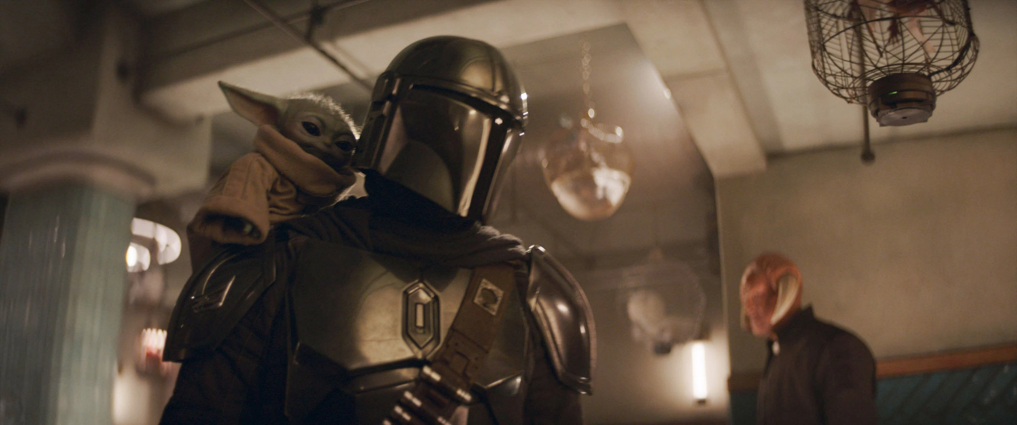 pedro pascal and grogu in a scene from star wars the mandalorian and grogu