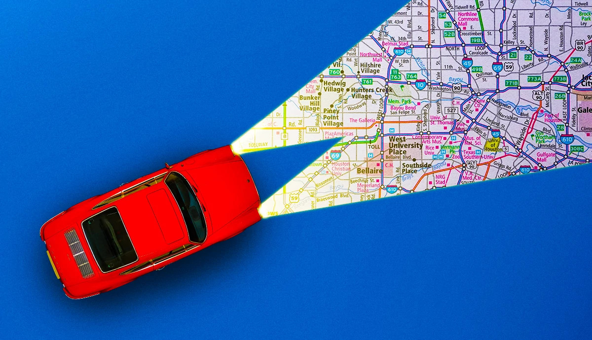 a car with its headlights illuminating a map