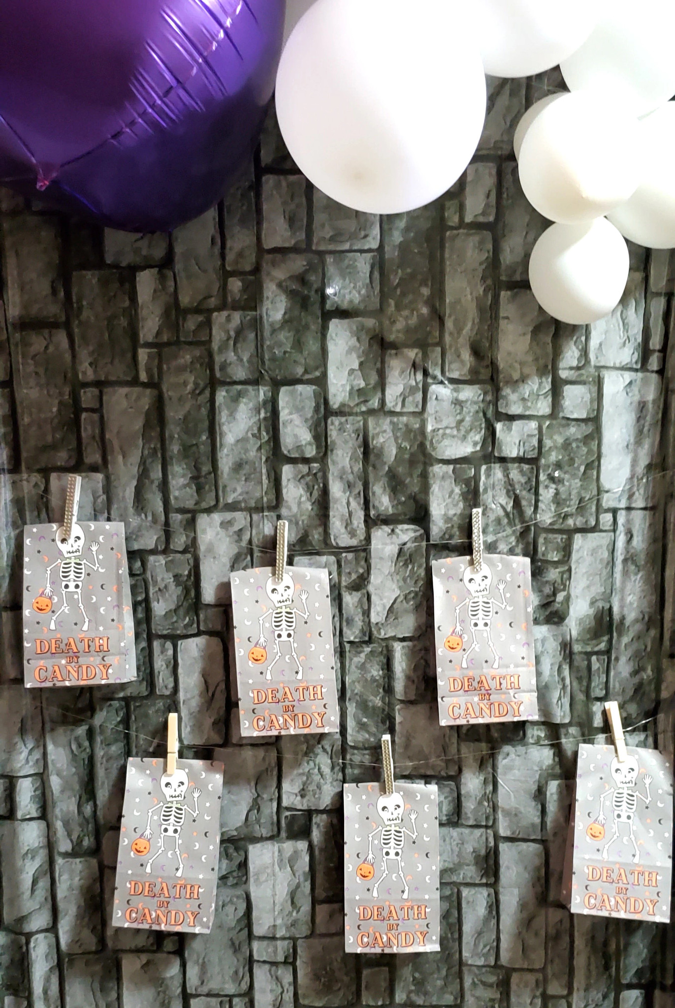 decorative halloween goodie bags hanging on a wall