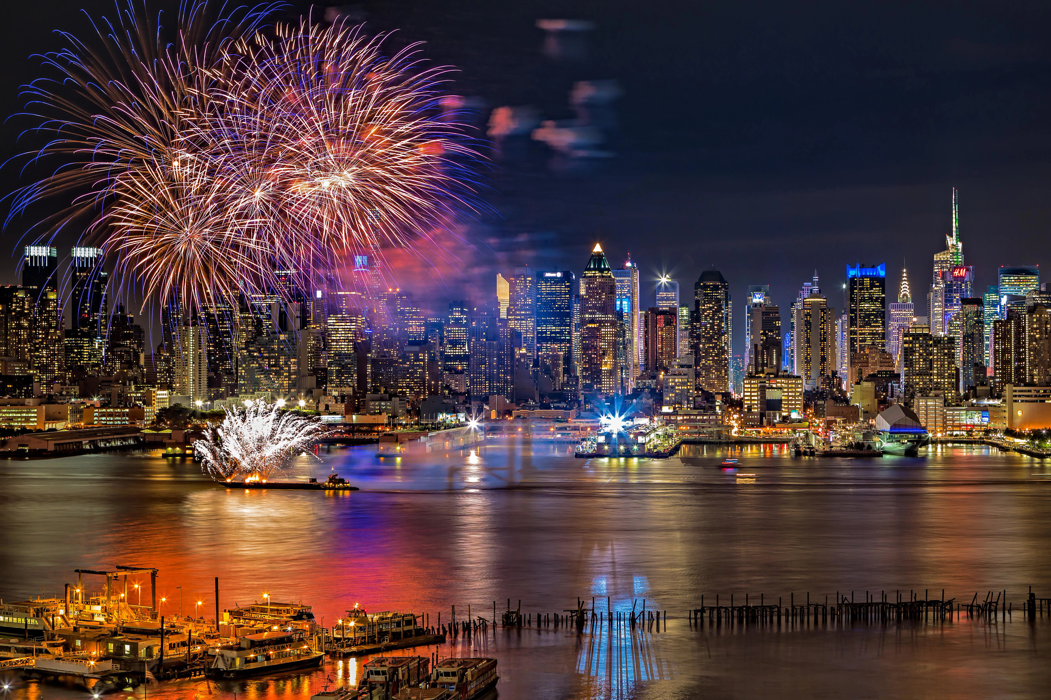 New York City July 4th fireworks Fireworks over the hudson river with illuminated skyscrapers