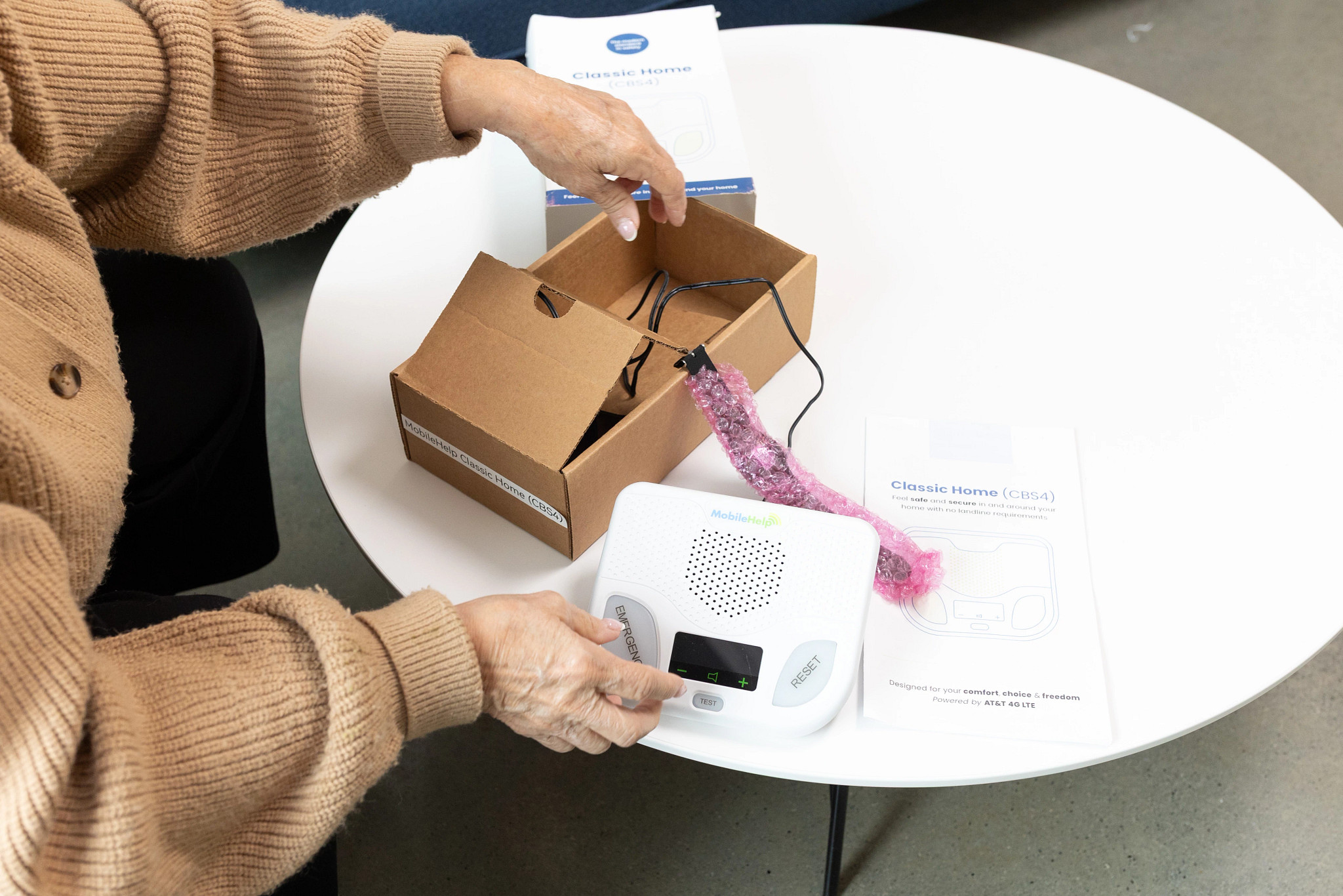 A person unboxing the MobileHelp Classic Home
