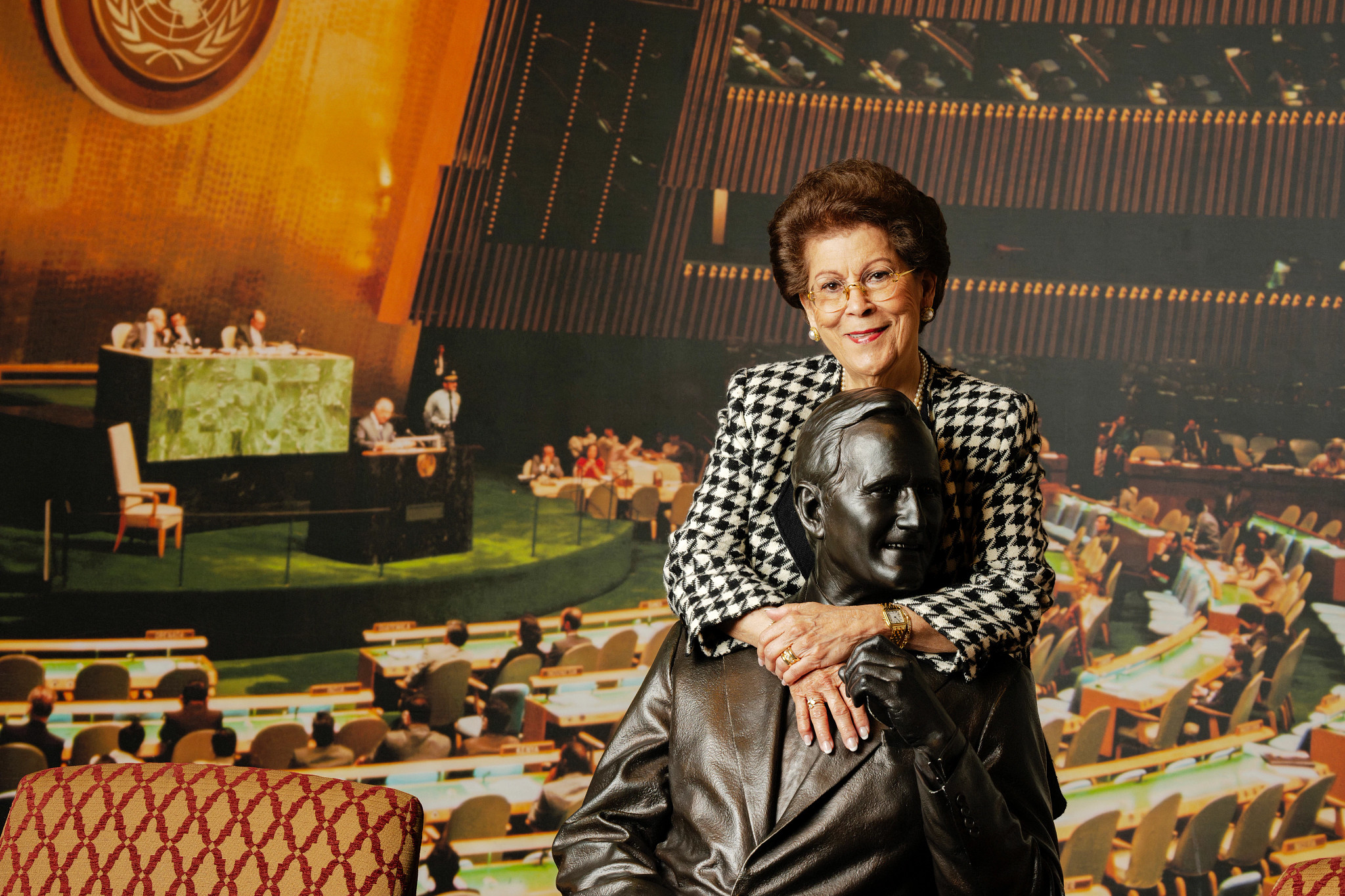 Antonia Novello, M.D. standing near a bust of President George H.W. Bush