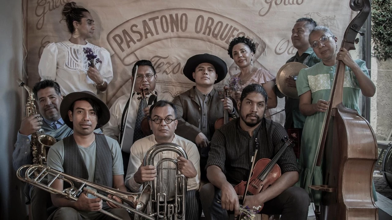 a group of musicians pose for a picture while holidng their instruments