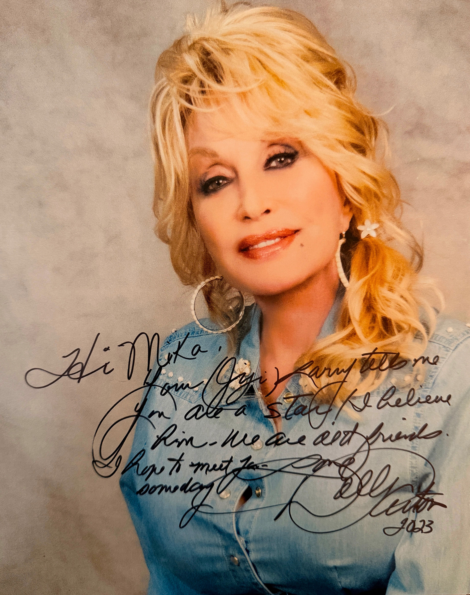 A photo of Dolly Parton with a personal note and autograph