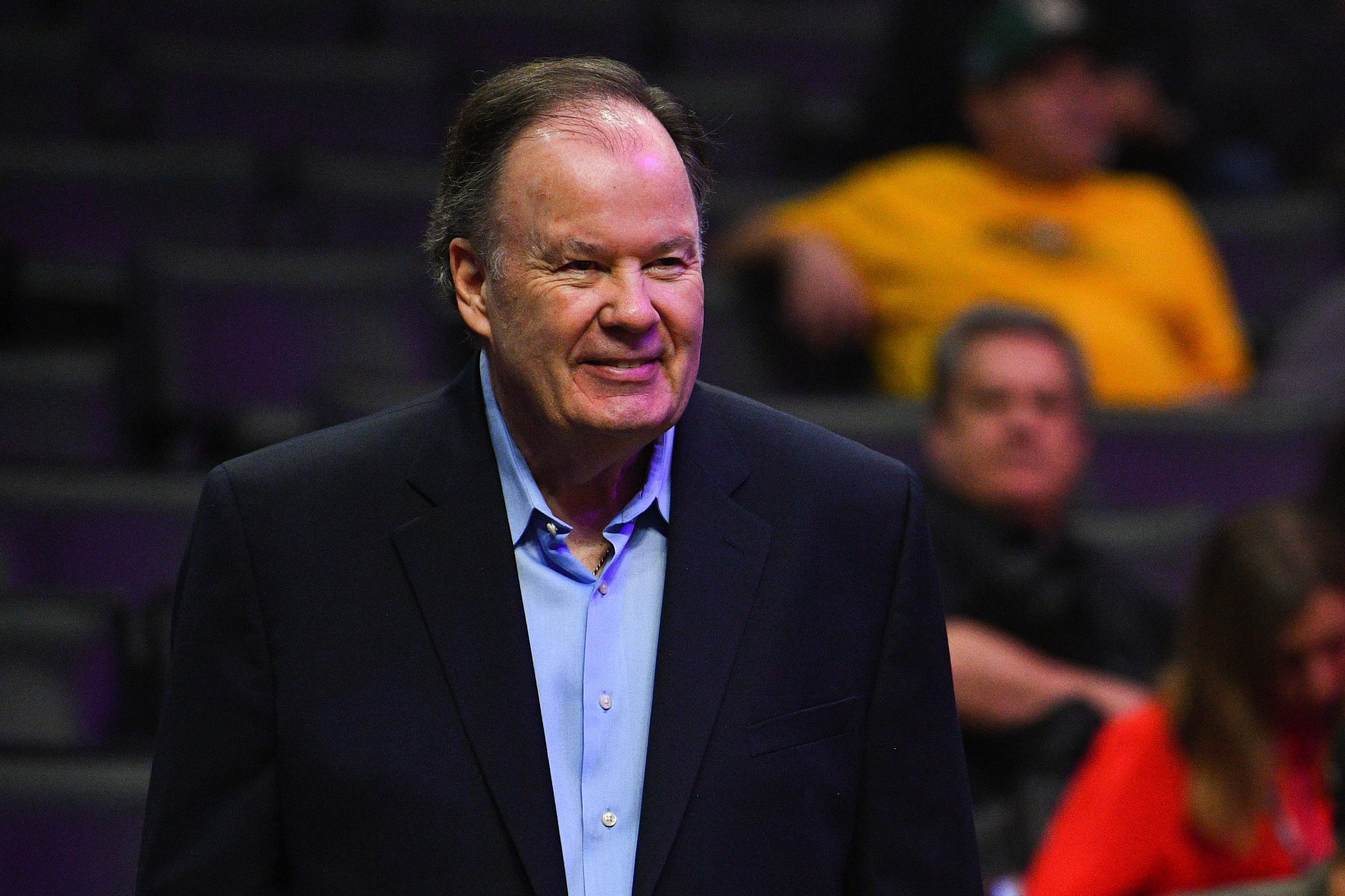 dennis haskins in a suit smiling