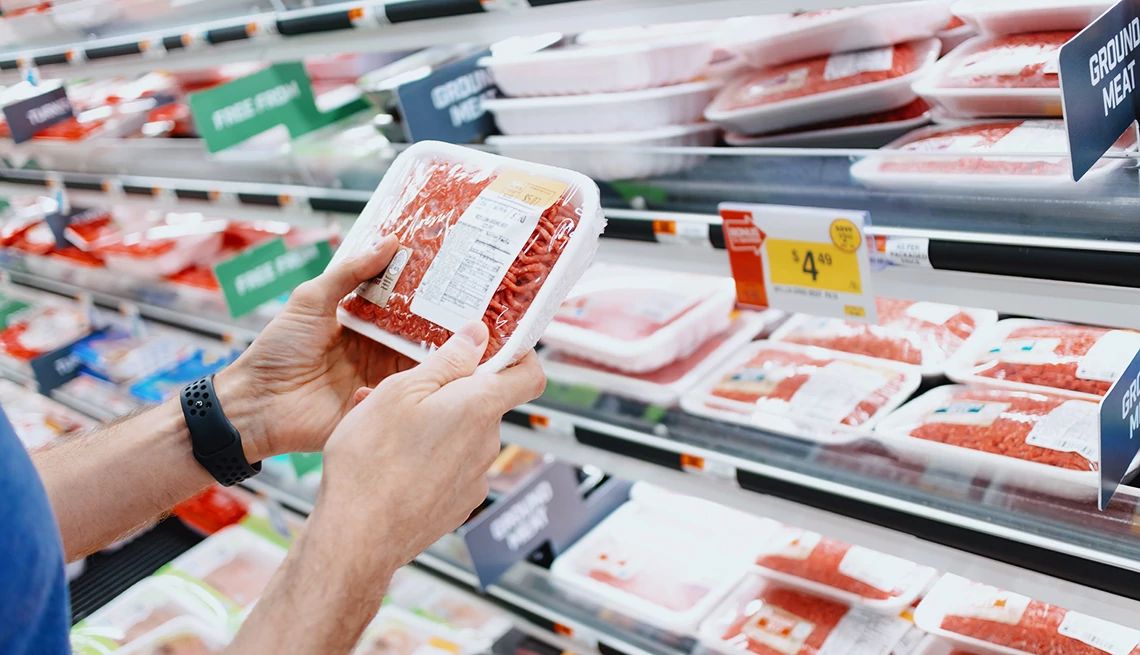 Walmart Ground Beef Recalled for E. Coli Concerns person holding ground beef at the super market