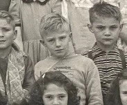 A photo shows Chester Pratt in a grade-school class photo, circa 1945