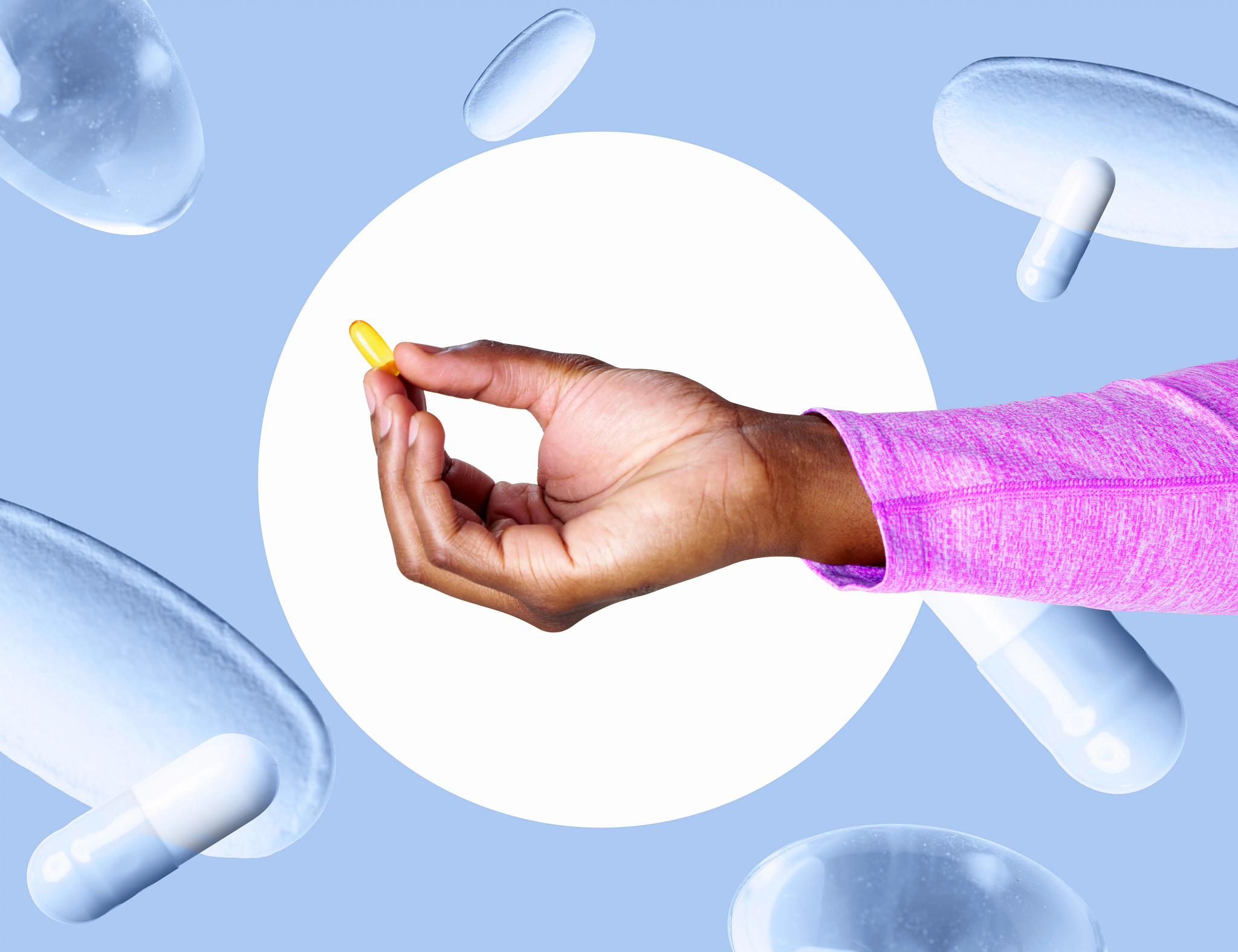 Hand holding single capsule against abstract background