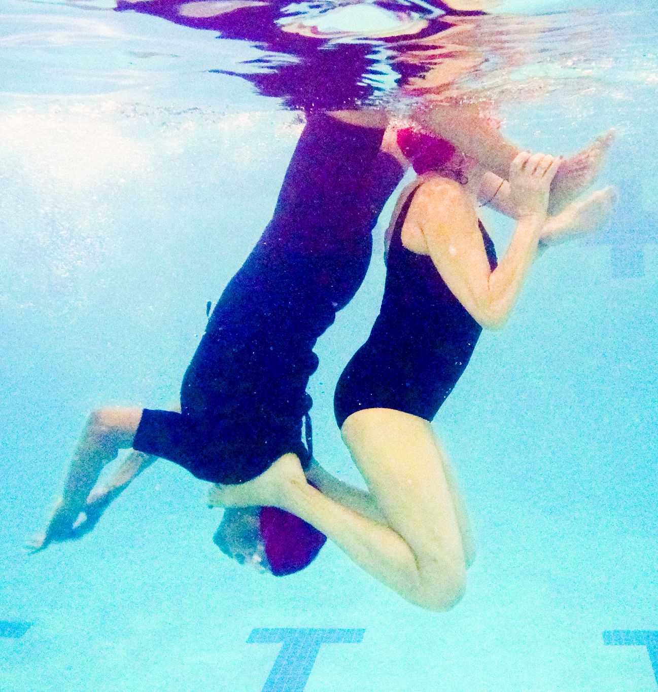 Water Ballet with a Purpose An underwater photo shows two Harlem Honeys and Bears members performing a maneuver