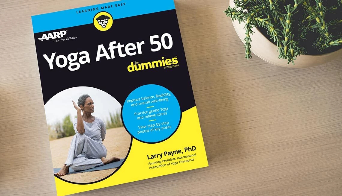 Yoga After 50 Book book on table with plant in corner