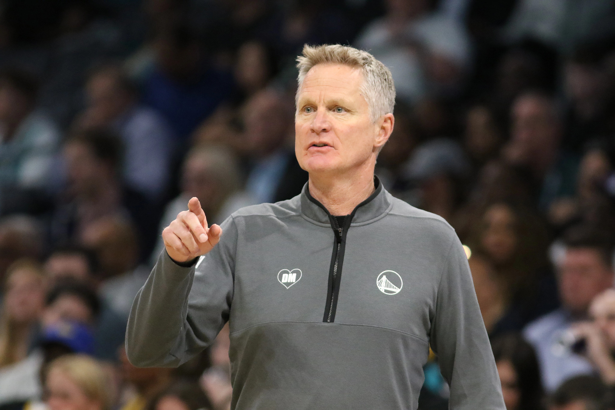 Head Coach Steve Kerr  with spectators blurred behind him