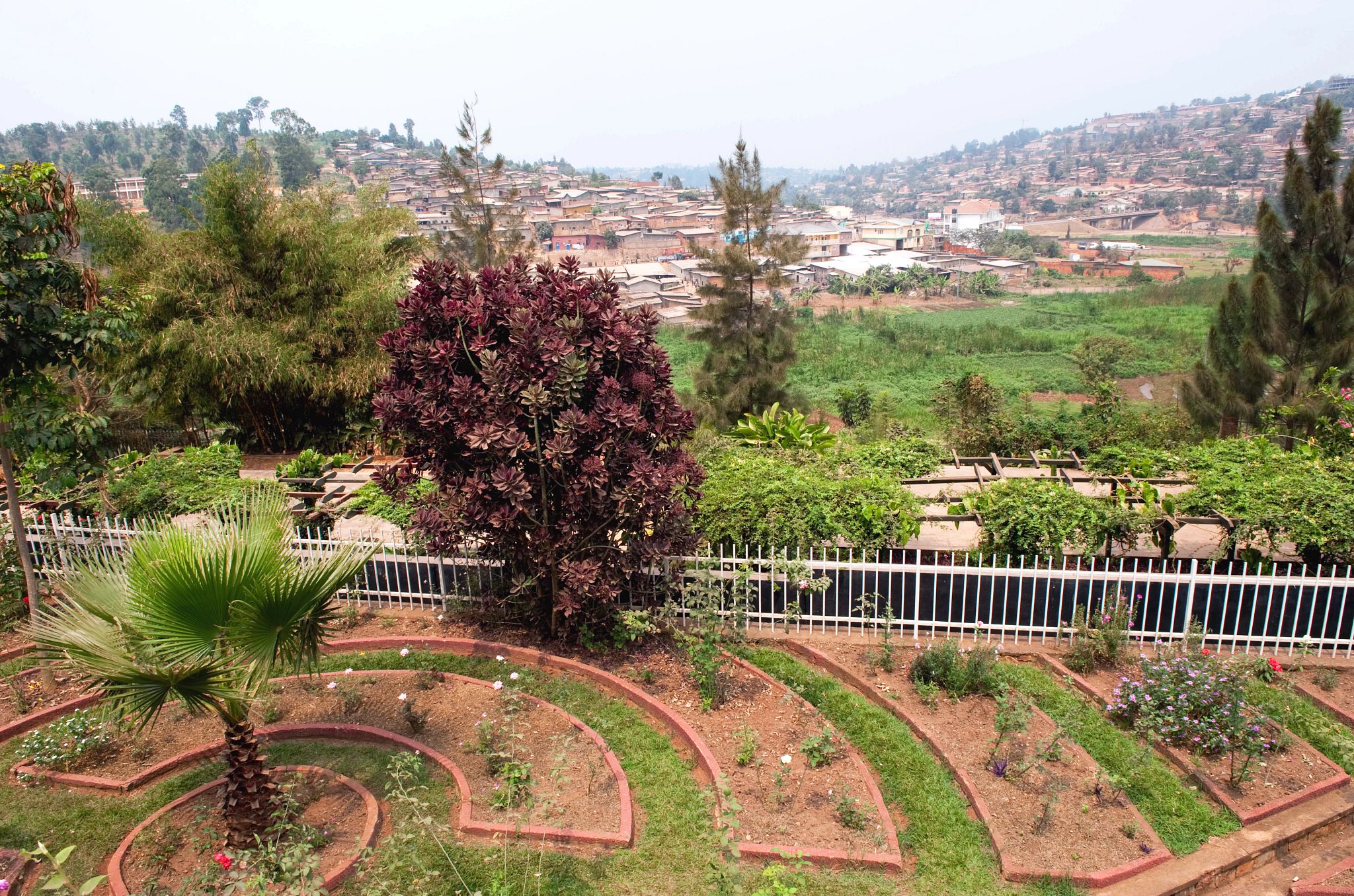 Kigali Genocide Memorial garden beds surronded by trees on a hillside
