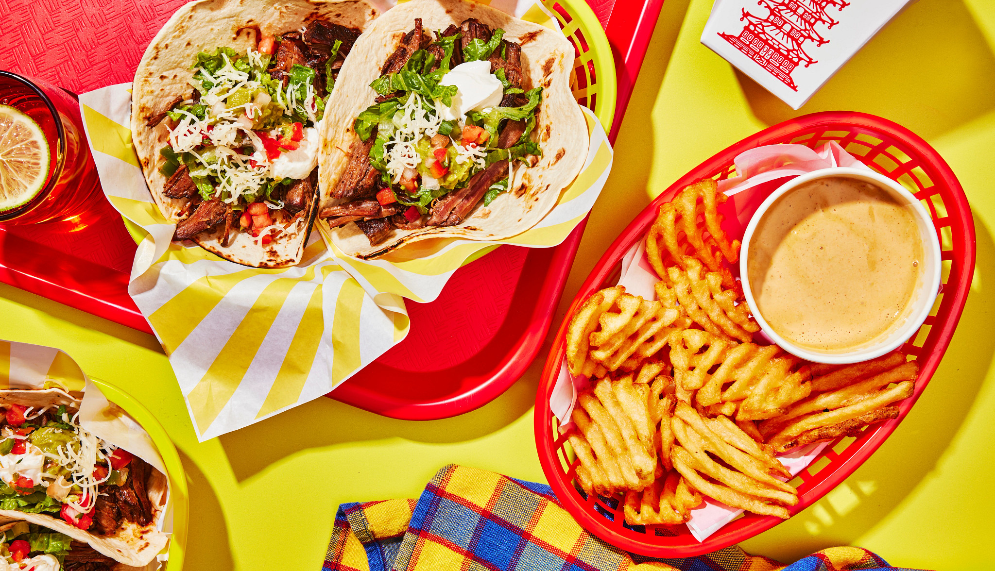 View from above of multiple copy cat recipes from tacos to sauce on a bright yellow background