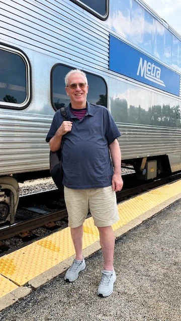 a photo shows author John McCormack standing outside a Chicago Metra train