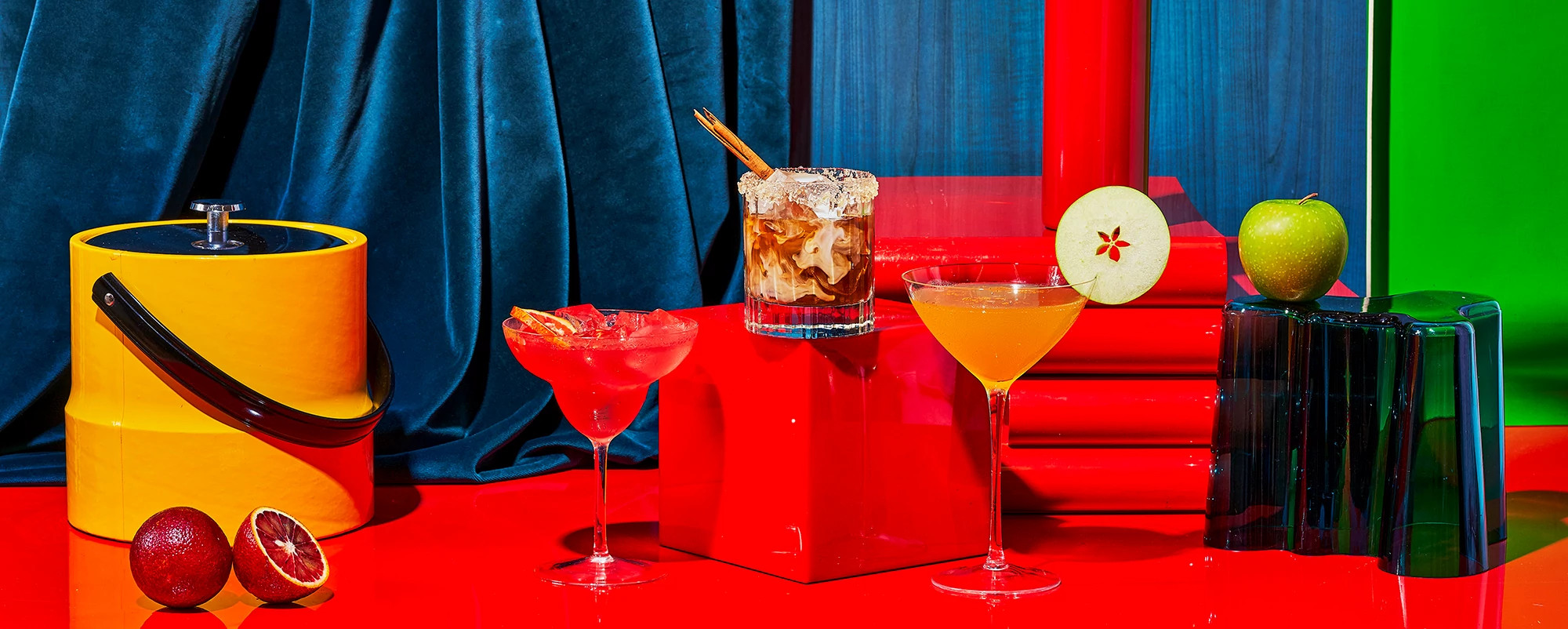 Pumpkin Spice White Russian, Blood Orange and Pomegranate Margarita and an Apple Martini on a colorful background