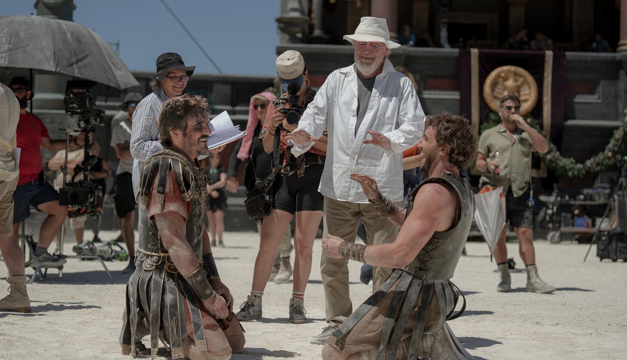 Gladiator picture from the filming of the gladiator movie where two actors are laughing and the director is standing in the background