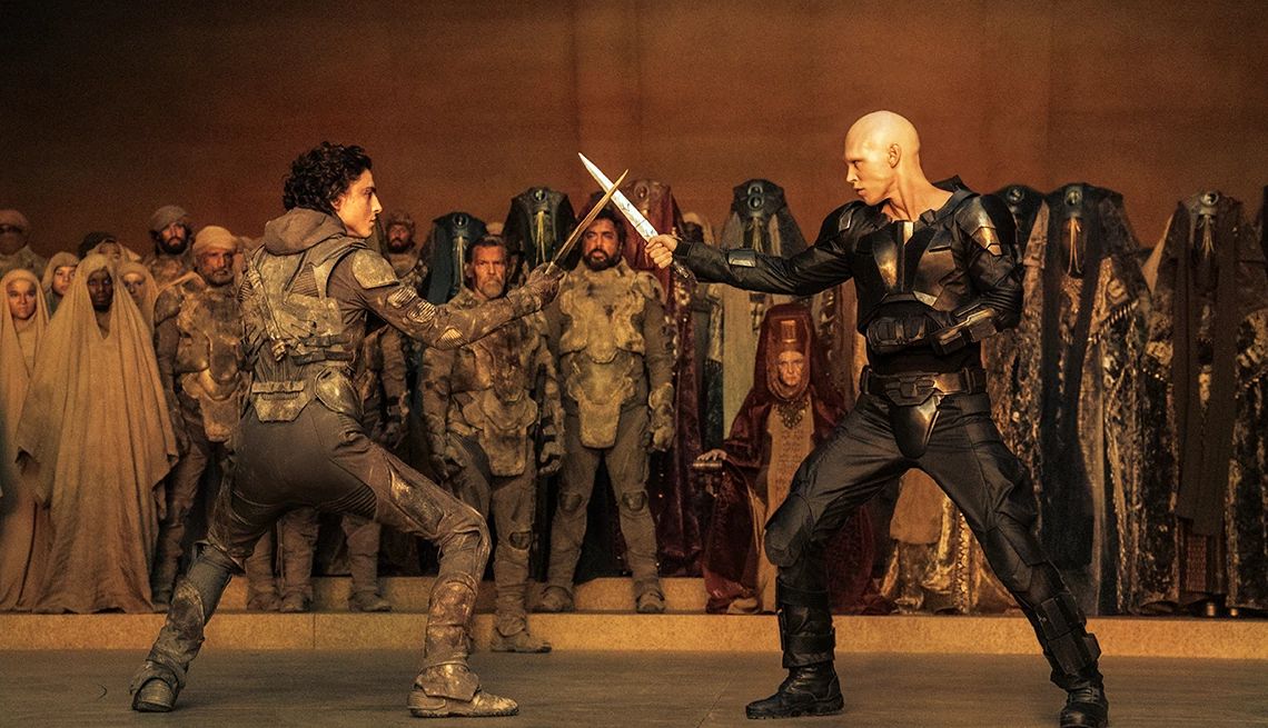 Timothée Chalamet and Austin Butler each holding a knife as they face off in a fight in "Dune: Part Two."