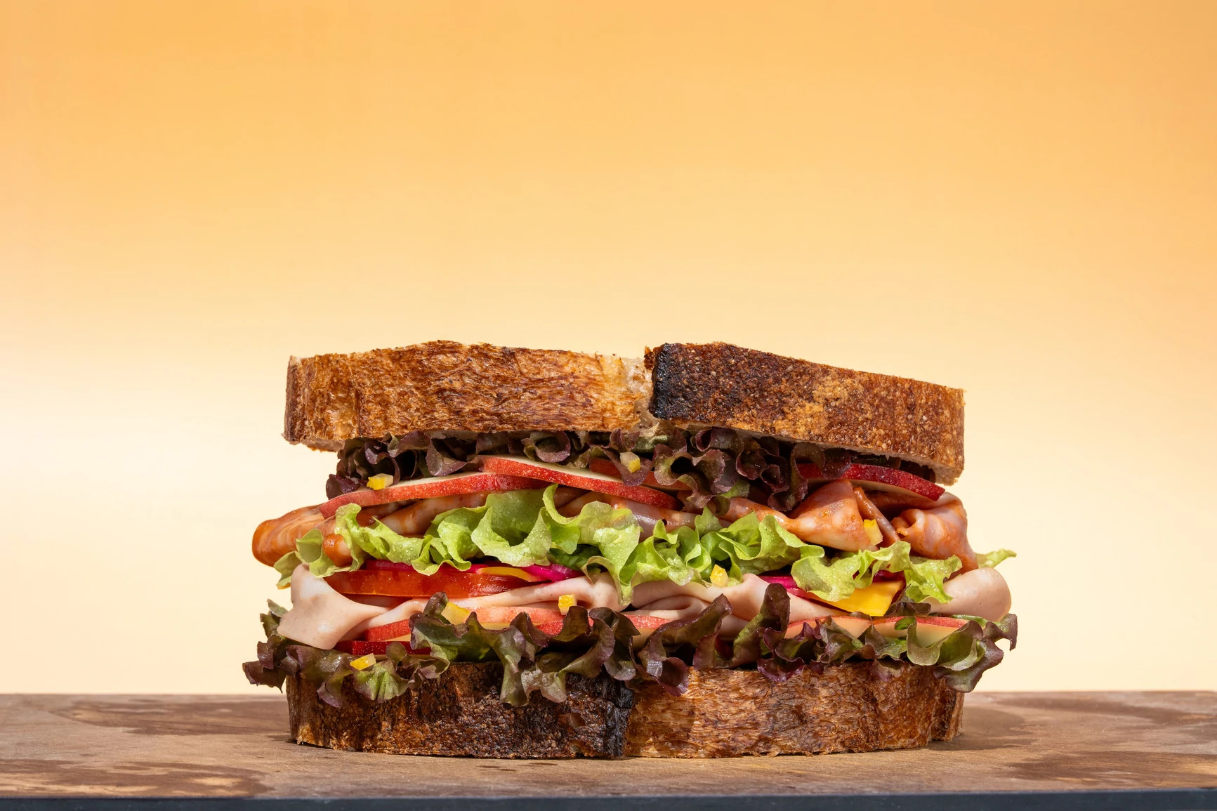 a photo shows a sandwich on a cutting board