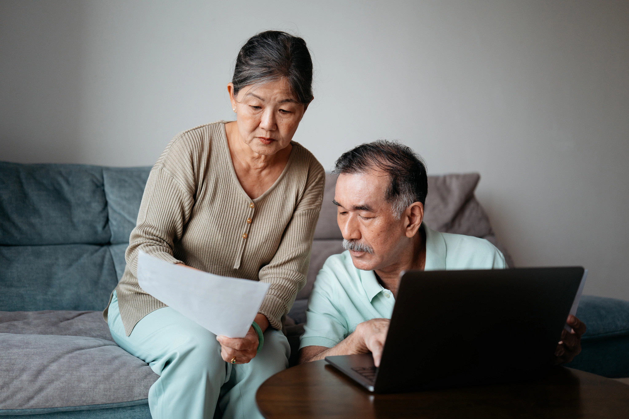 a couple looking at bills