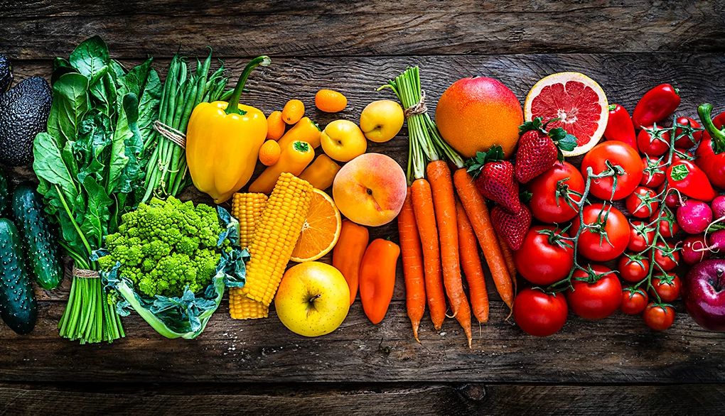 Plant-based diets are associated with better brain health An overhead view of colorful fruits and vegetables on a wooden table