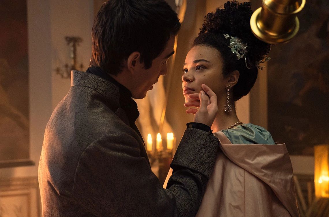 Corey Mylchreest and India Amarteifio in the Netflix series Queen Charlotte A Bridgerton Story Corey Mylchreest touches India Amarteifio's face with his hand in a scene from Queen Charlotte A Bridgerton Story