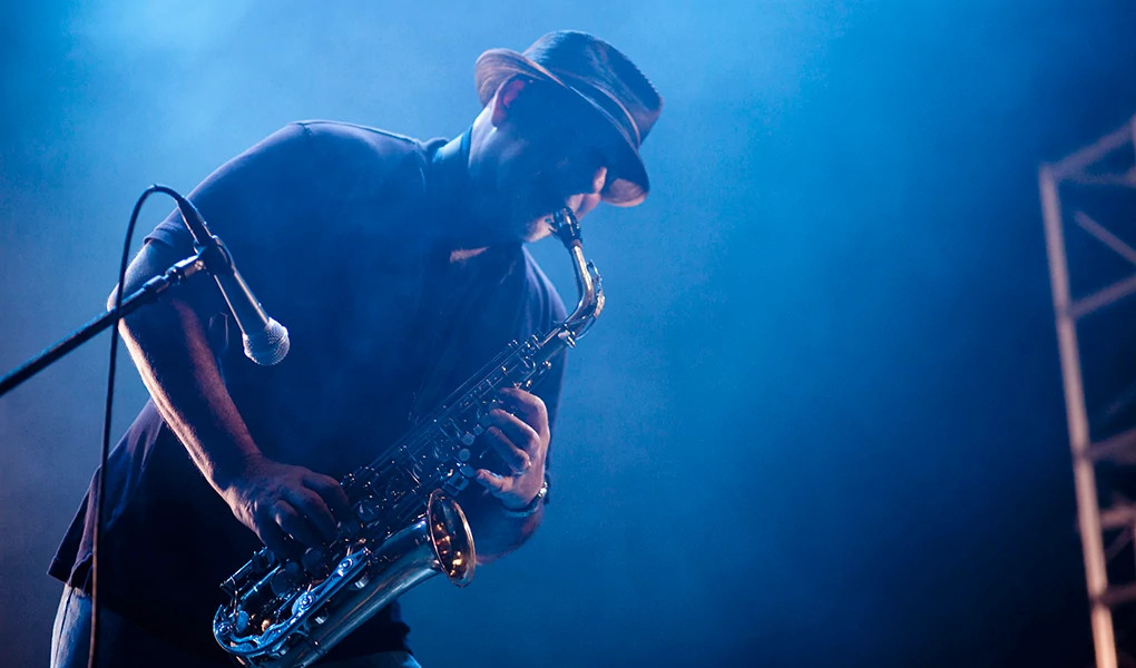 A man playing a saxophone on stage