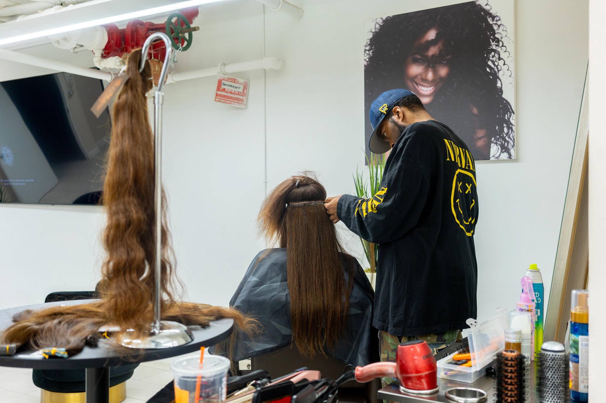 woman getting hair tape integration system installed by celebrity stylist