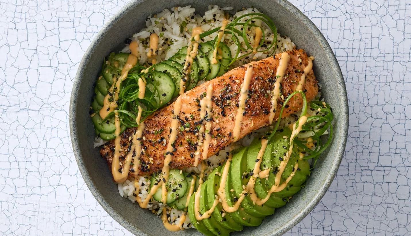 Salmon Rice Bowls Recipe Rice, salmon, cucumber, avocado, scallions and spices in bowl