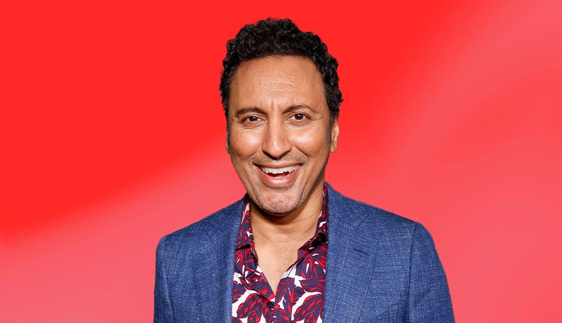 Aasif Mandvi interview Aasif Mandvi against red ombre background