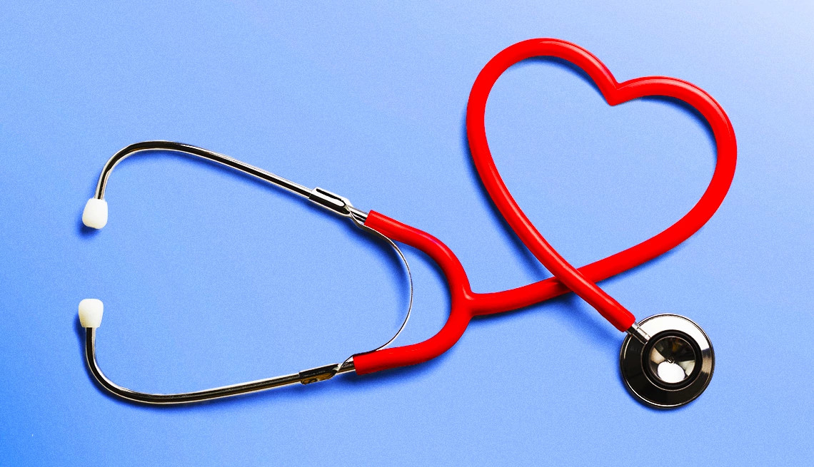 Red stethoscope shaped into a heart on a bright blue background