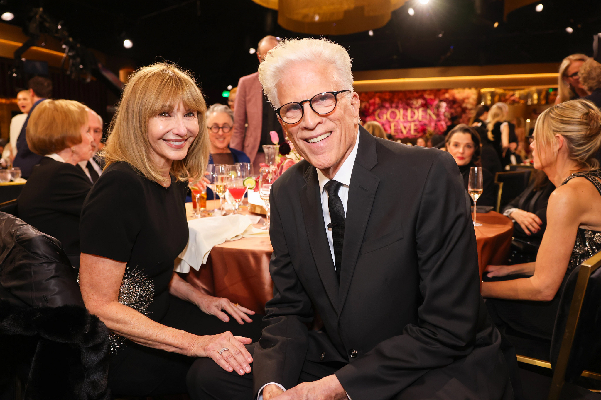 mary steenburgen and ted danson posing together at a table